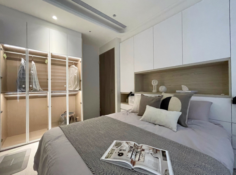 空間以白色搭配暖色木紋為主,因大量收納而使用鋁框玻璃門,在空間視覺上做到輕量化的設計,使空間感受不那麼壓迫