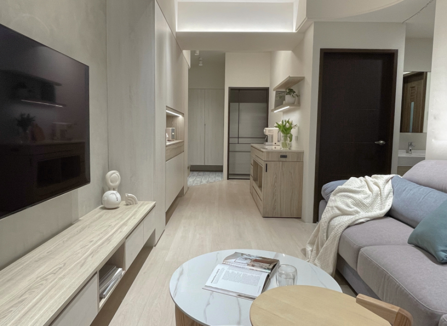 空間整體以暖色木紋為主,搭配電視牆低飽和度的灰色塗料,使整體空間帶有天然材質且明亮