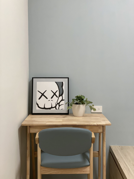 空間整體以白色及暖色調木紋為主,設計臥榻兼具收納及待客使用,搭配牆面中性色跳色增加空間的穩重性